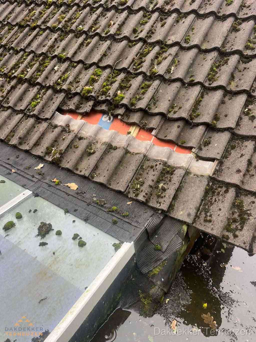 Beschadigd pannendak met ontbrekende dakpannen voor reparatie in Terneuzen