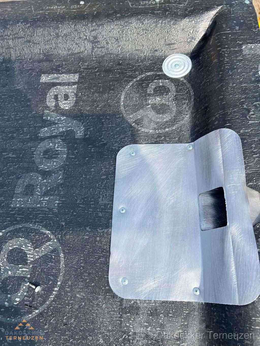 Dakdoorvoer met metalen afvoerplaat op bitumen dak in Terneuzen